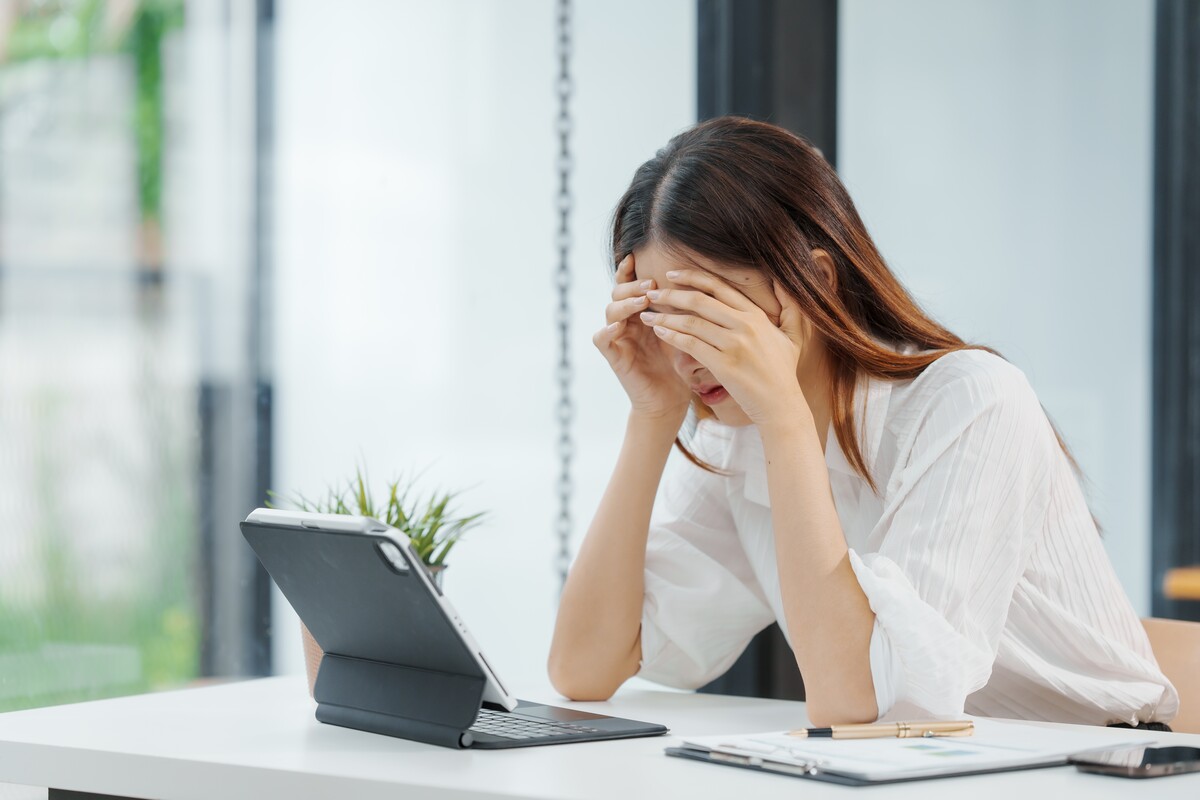 struggling business - Businesswoman feeling stressed at her company office